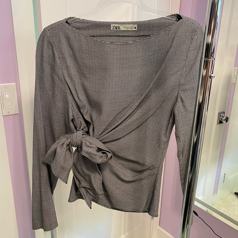 Black and white (comes across grey) wide neck side tie blouse